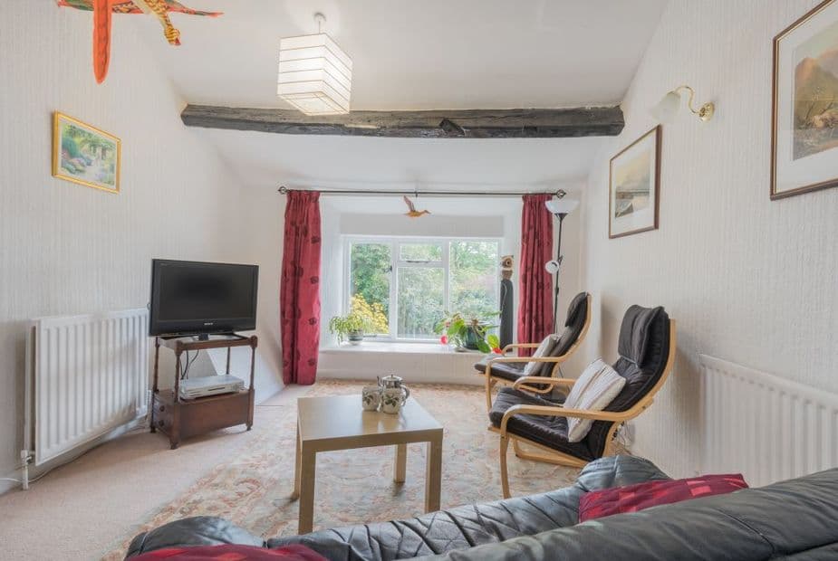 The open plan &quot;L&quot; shaped living-dining room at the apartment