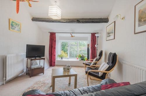 The open plan &quot;L&quot; shaped living-dining room at the apartment
