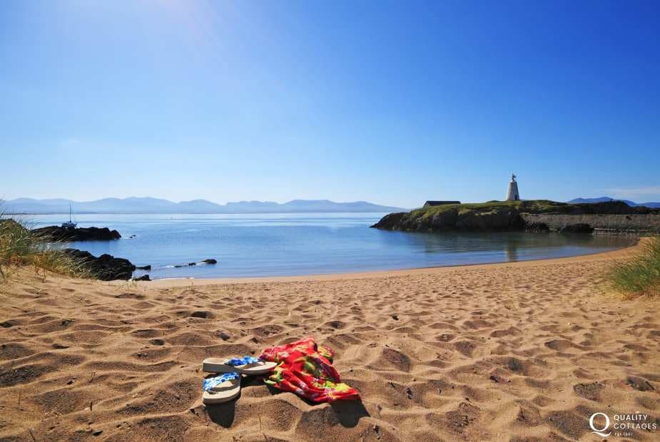 Take a day trip to Anglesey from Nefyn. Here you can see the mountains of the Lleyn Peninsula from Llanddwyn Island