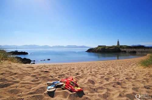 Take a day trip to Anglesey from Nefyn. Here you can see the mountains of the Lleyn Peninsula from Llanddwyn Island