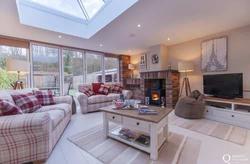 Luxury open plan living room with wood burner and Bi-fold doors to the garden