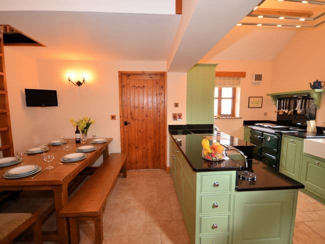 Kitchen/dining area showing access to single bedroomvia vertical ladder