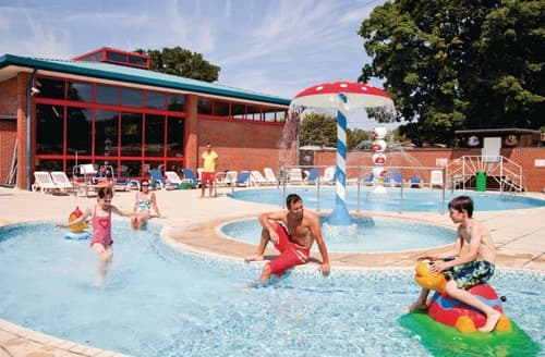 Outdoor swimming pool with water jets