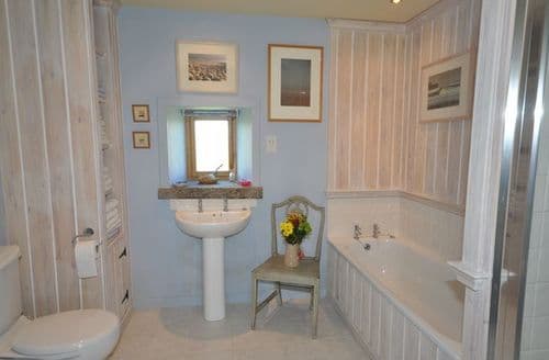 Spacious bathroom with bath and shower cubicle