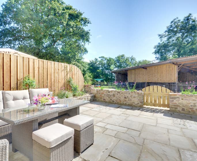 The spacious patio has very comfortable seating and a large table to enjoy al fresco dining