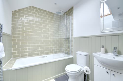 A stylish family bathroom with shower over bath