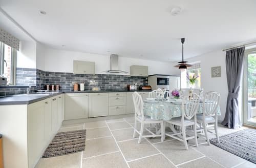 The well equipped kitchen has plenty of room and French doors which lead out to the private paved patio area