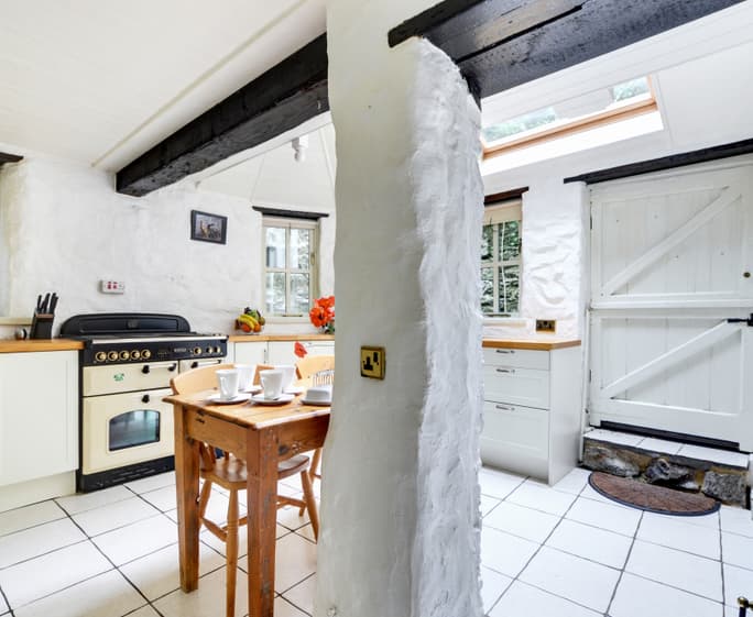 The kitchen with breakfast table, butler sink and  electric woodburner