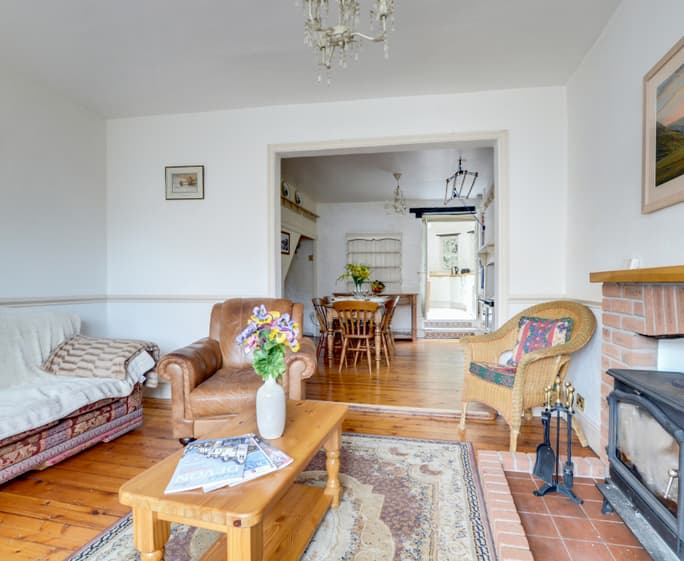 The log burning stove is flanked by comfy seating