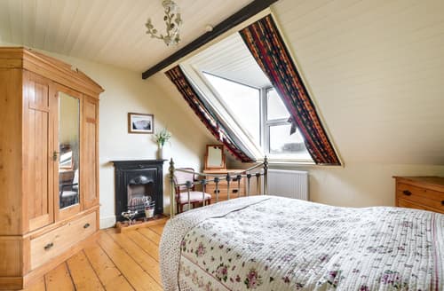 The stylish master bedroom on the second floor enjoys wonderful sea views in one direction and beautiful countryside views in the other 