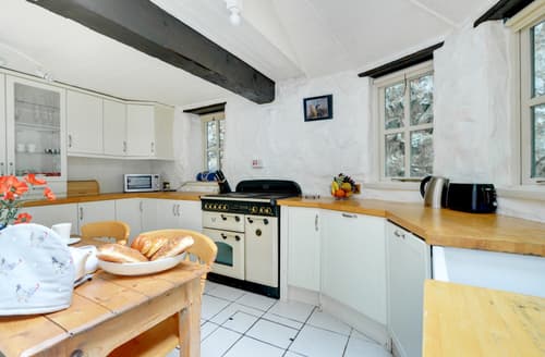 The attractive shaker style breakfast kitchen features oak beams and butler sink