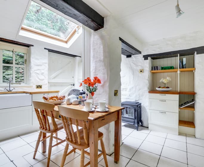 The attractive shaker style breakfast kitchen features oak beams and butler sink