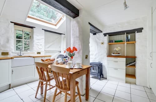 The attractive shaker style breakfast kitchen features oak beams and butler sink