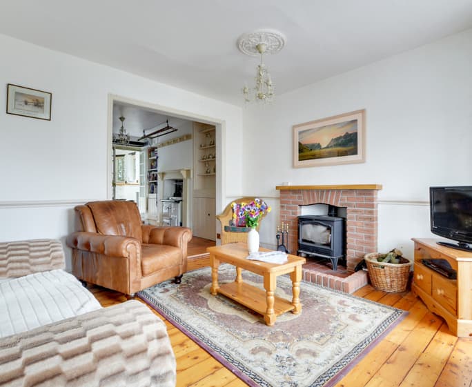 The log burning stove is flanked by comfy seating