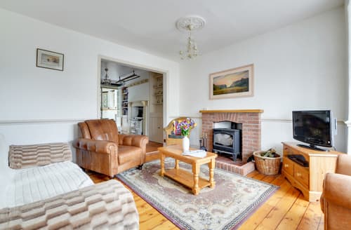 The log burning stove is flanked by comfy seating