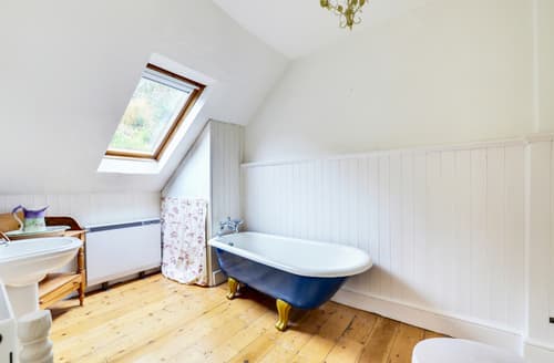 The spacious family bathroom with roll top bath