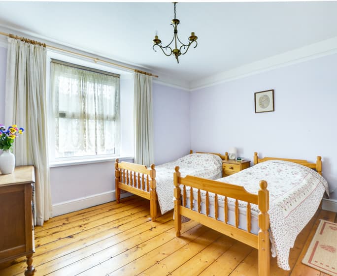 On the first floor there is a twin room with original feature fireplace 