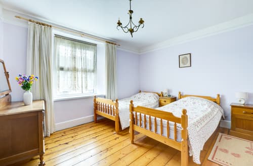 On the first floor there is a twin room with original feature fireplace 