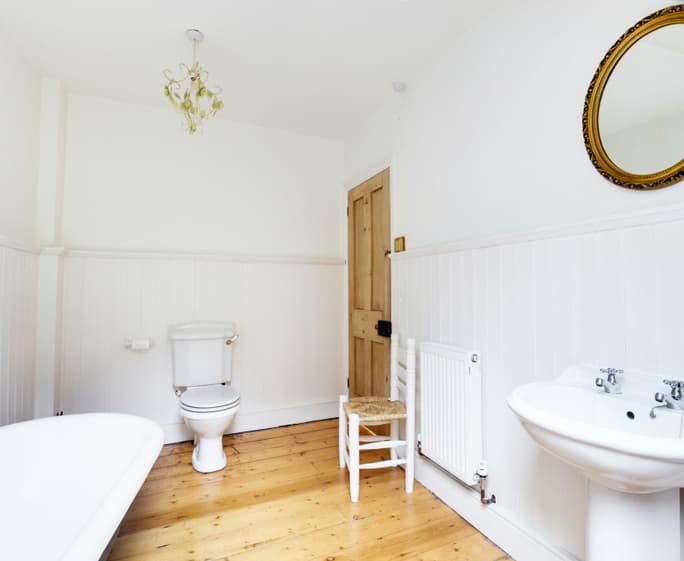 The spacious family bathroom with roll top bath