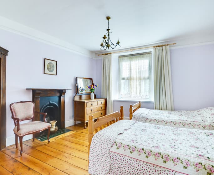 On the first floor there is a twin room with original feature fireplace 