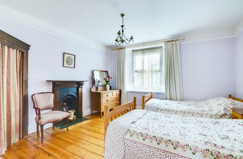 On the first floor there is a twin room with original feature fireplace 