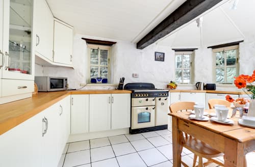 The attractive shaker style breakfast kitchen features oak beams and butler sink