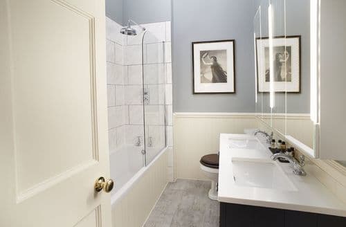 First floor: En-suite bathroom with bath and shower over