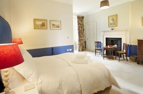 First floor: Bedroom four with king size bed and en-suite shower room