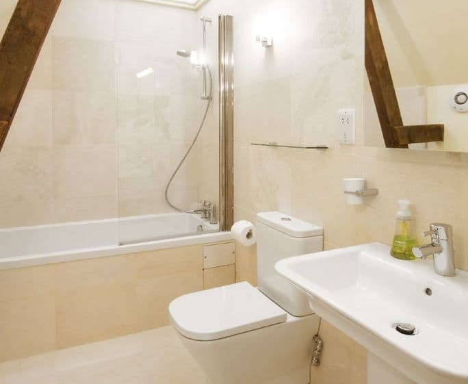 First floor:  En-suite bathroom with bath, hand held shower, basin and WC