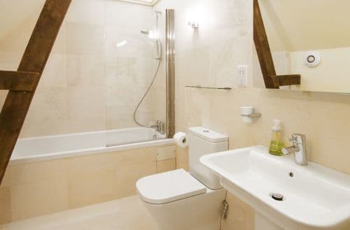 First floor:  En-suite bathroom with bath, hand held shower, basin and WC