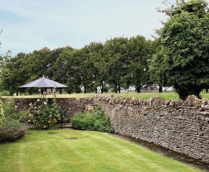 A path from the back door leads to the walled garden, with patio and pleasant views over the fields