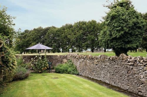 A path from the back door leads to the walled garden, with patio and pleasant views over the fields