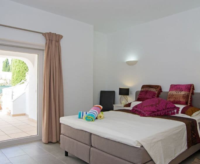 Ground floor: Master bedroom with en-suite shower room and doors to the covered terrace