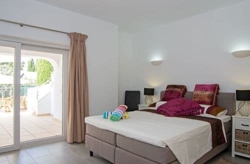 Ground floor: Master bedroom with en-suite shower room and doors to the covered terrace