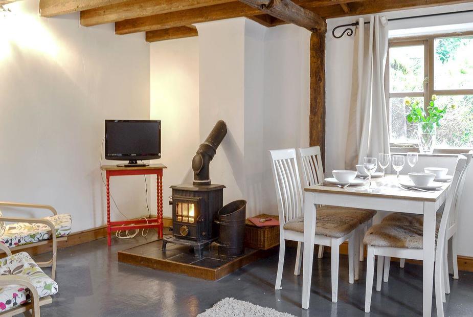 Ty Uchaf Charming, cosy living/ dining room with beamed cieling | Ty Uchaf - Glyngynwydd Cottages and Wedding Barn, Glyngynwydd, near Llanidloes