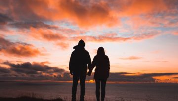 A couple outside a luxury Lake District cottage for couples