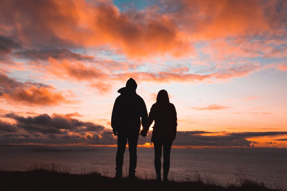 A couple outside a luxury Lake District cottage for couples