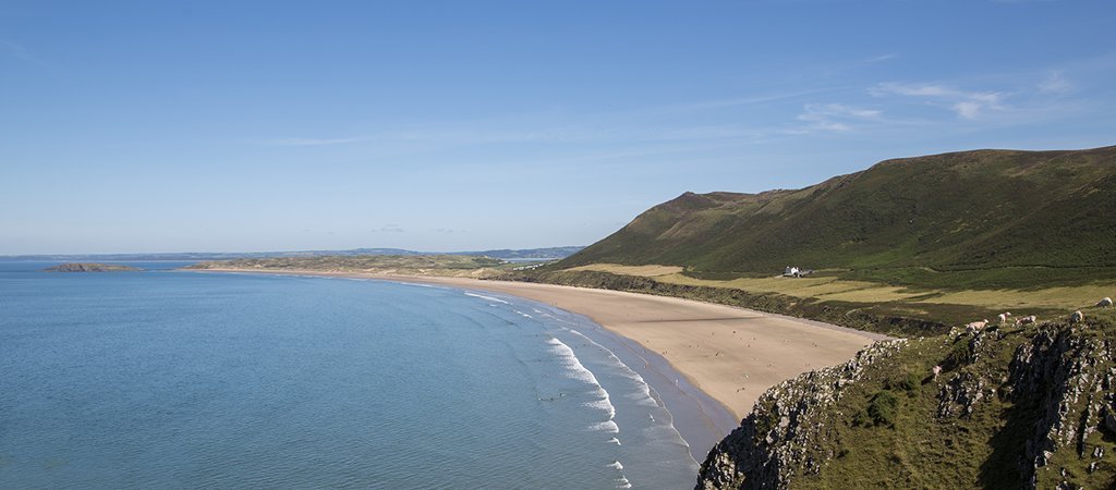 Surfing in Gower, one of the outdoor activities for adults UK