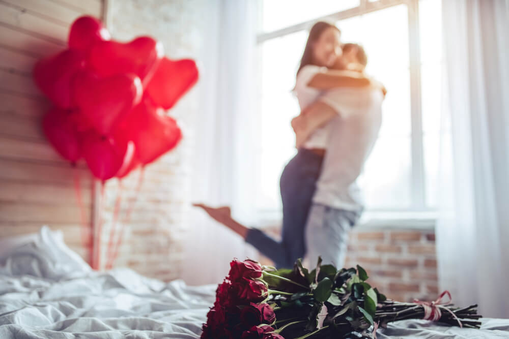 A partner surprising their other half with a Valentines staycation